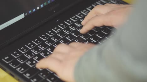 Typing on laptop keyboard - closeup shot