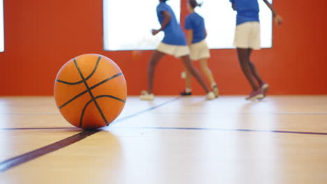 playing basketball in school gym, kids practicing and having fun together