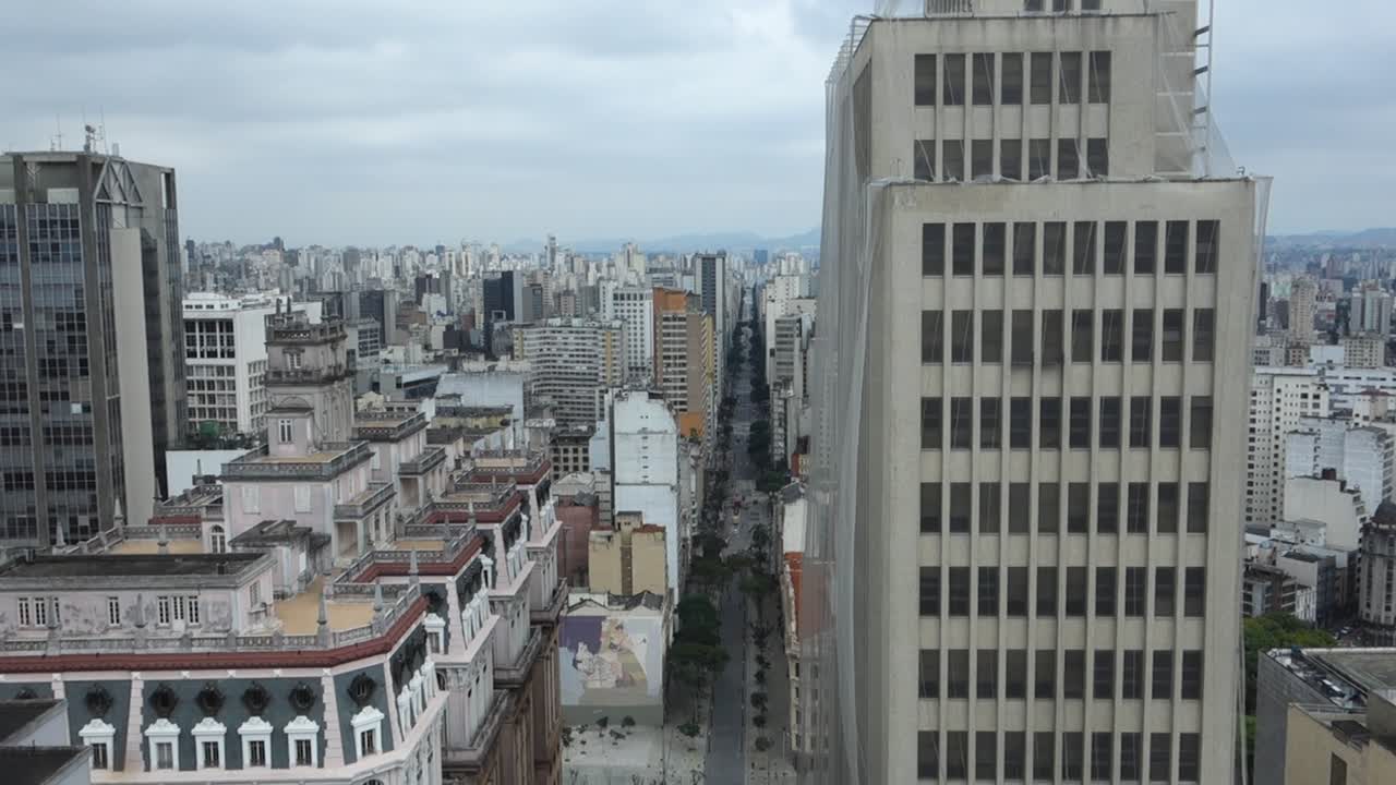 inclinación aérea hacia arriba que revela una jungla de piedra y una amplia avenida en la ciudad de sao paulo, brasil