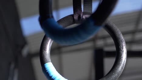 close up shot of black metal gymnastic rings at the gym