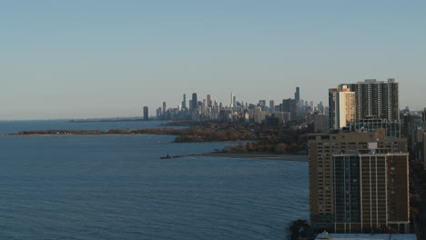 aerial footage of a wintery day north of chicago with lake michigan and downtown chicago skyline in the background in the late afternoon