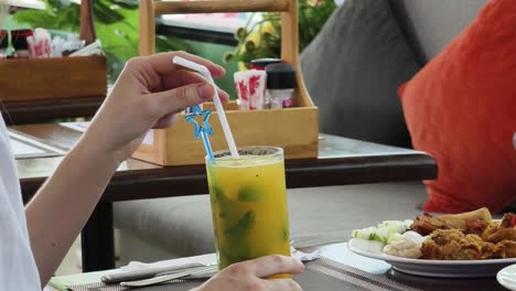 woman enjoying a drink at a restaurant