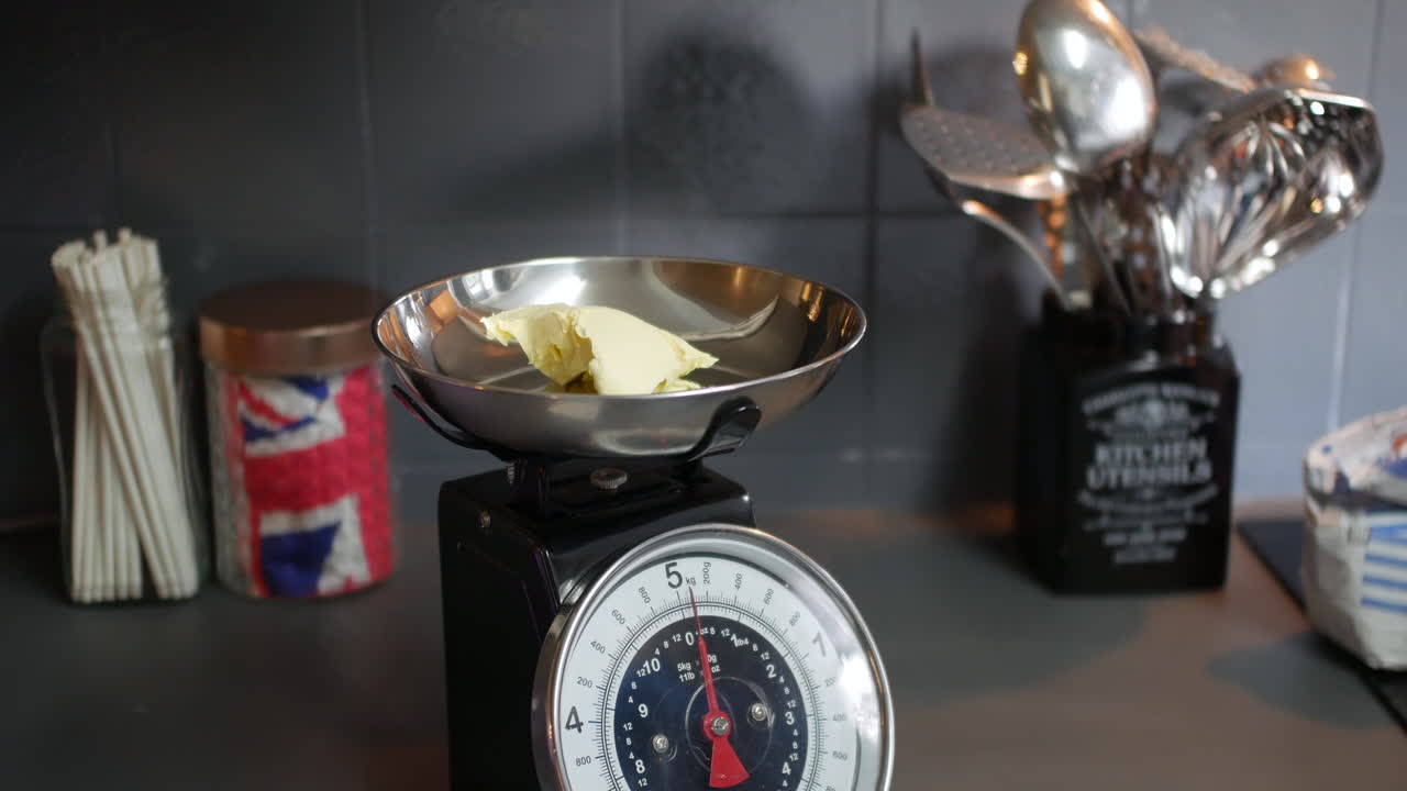 Weighing butter on scales for cooking and baking a cake