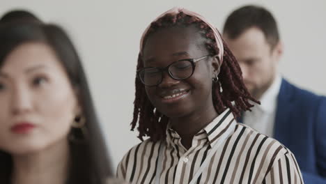 african woman smiling on conference