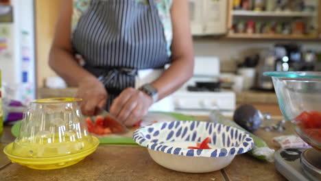 cutting up tomatoes to add to a chopped salad - antipasto salad series