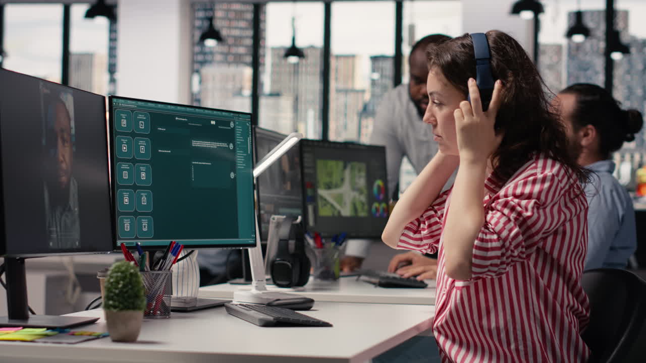 Woman in Headphones on Video Call Working at Computer in Modern Office