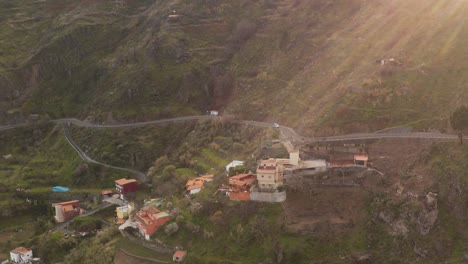 drone shot of an car driving on a street in the mountains