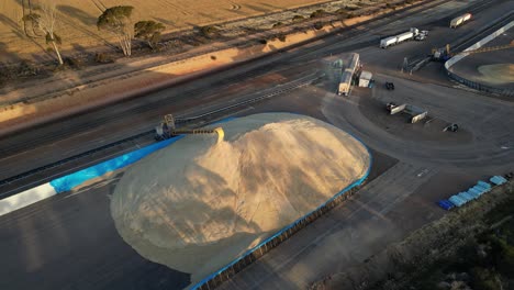 aerial view of unloading cargo truck, transport grains on heap with belt conveyor