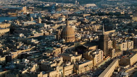 drone shot circling the bażilika santwarju tal-madonna tal-karmnu, sunny evening in valletta, malta