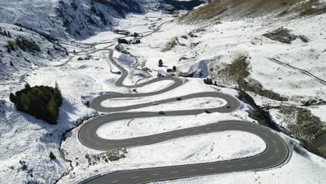 aerial view of winding mountain road in winter