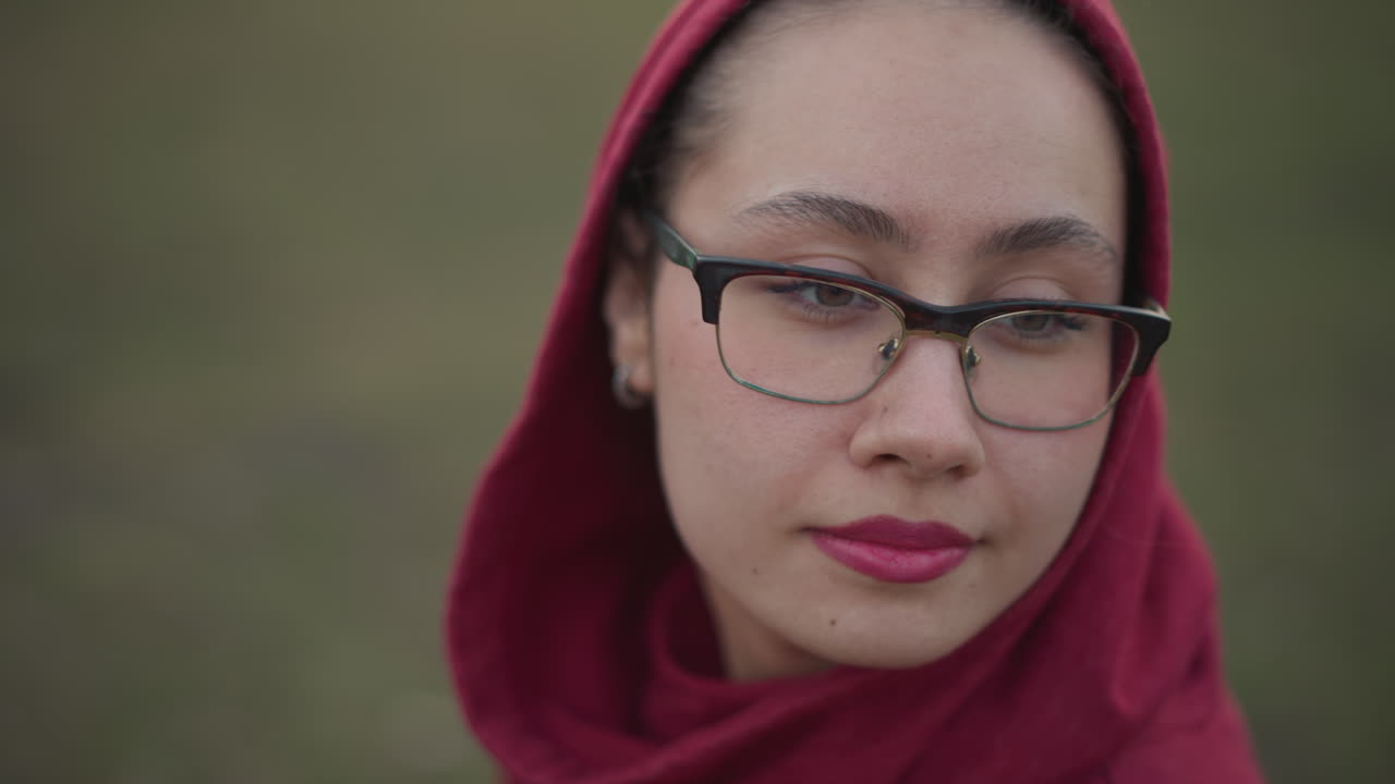 Seorang remaja wanita menikmati lingkungan luar ruangan yang segar, seorang wanita muda menikmati ketenangan di lanskap alam yang luas, seorang wanita muda dengan tenang membenamkan dirinya di pedesaan terbuka yang luas dan indah