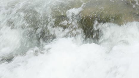 a powerful stream forming a waterfall gushes fast with white water over the rocks of the western ghats during the monsoon season when its heavy rain in india