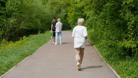 elderly caregiver and patient walking in park