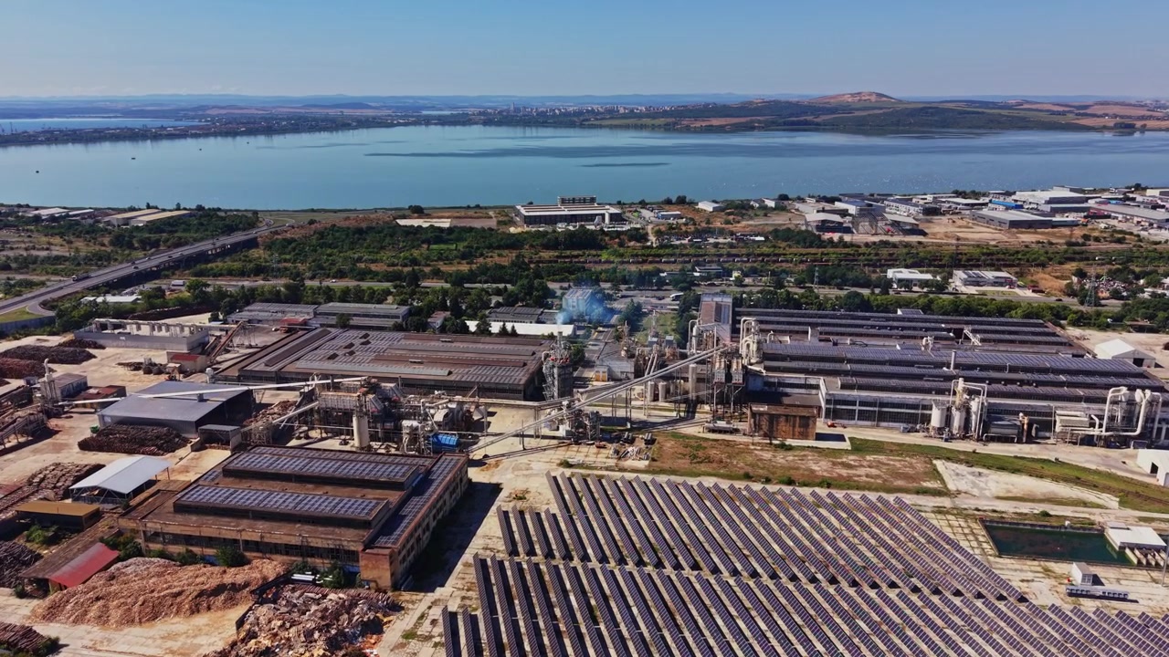 Industrial area near water with buildings and solar panels