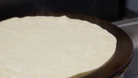 crepe cooking side view in slow motion