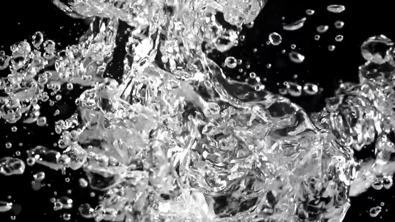 Close-up of Clear Water Bubbles Moving Against Black Background
