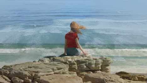 Red-haired-woman-sitting-by-the-beach