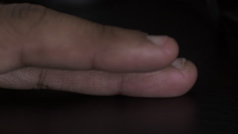 Ethnic-Minority-Fingers-Tapping-Alternately-On-Black-Desk