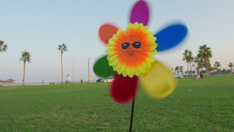 Primer-Plano-Para-Juguetes-De-Molino-De-Viento-De-Color-Arco-Iris-Para-Niños-Juguete-En-La-Playa