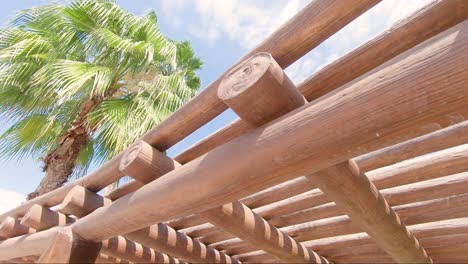 looking up at a wooden sun roof at a tropical beach