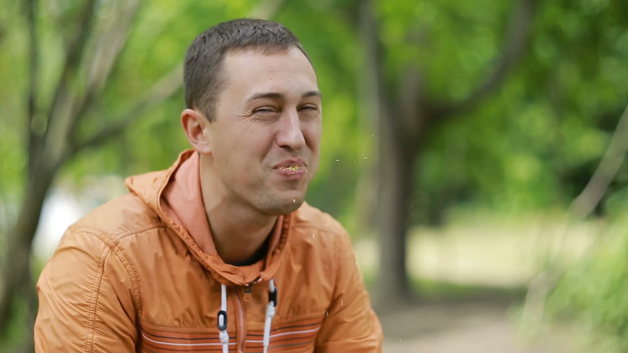 Man Having A Cookies. Smiling young man having a cookies in nature