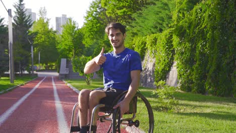 the disabled young man looks at the camera, smiles and says okay.