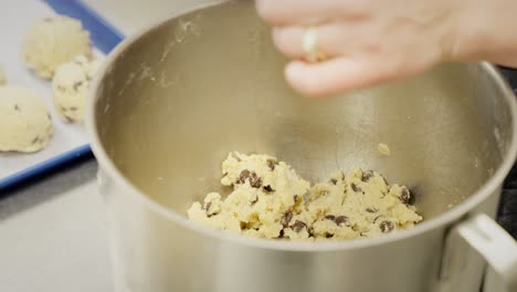 preparing chocolate chip cookie dough in a mixing bowl
