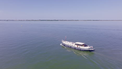 the timeless charm of a dutch luxemotor barge sailing through the still waters of flevoland