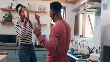 Dance,-singing-and-couple-in-kitchen-for-cooking