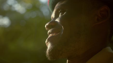 Side-View-Of-African-Warrior-From-Karamoja-Smiling-With-Sunlight-On-His-Face