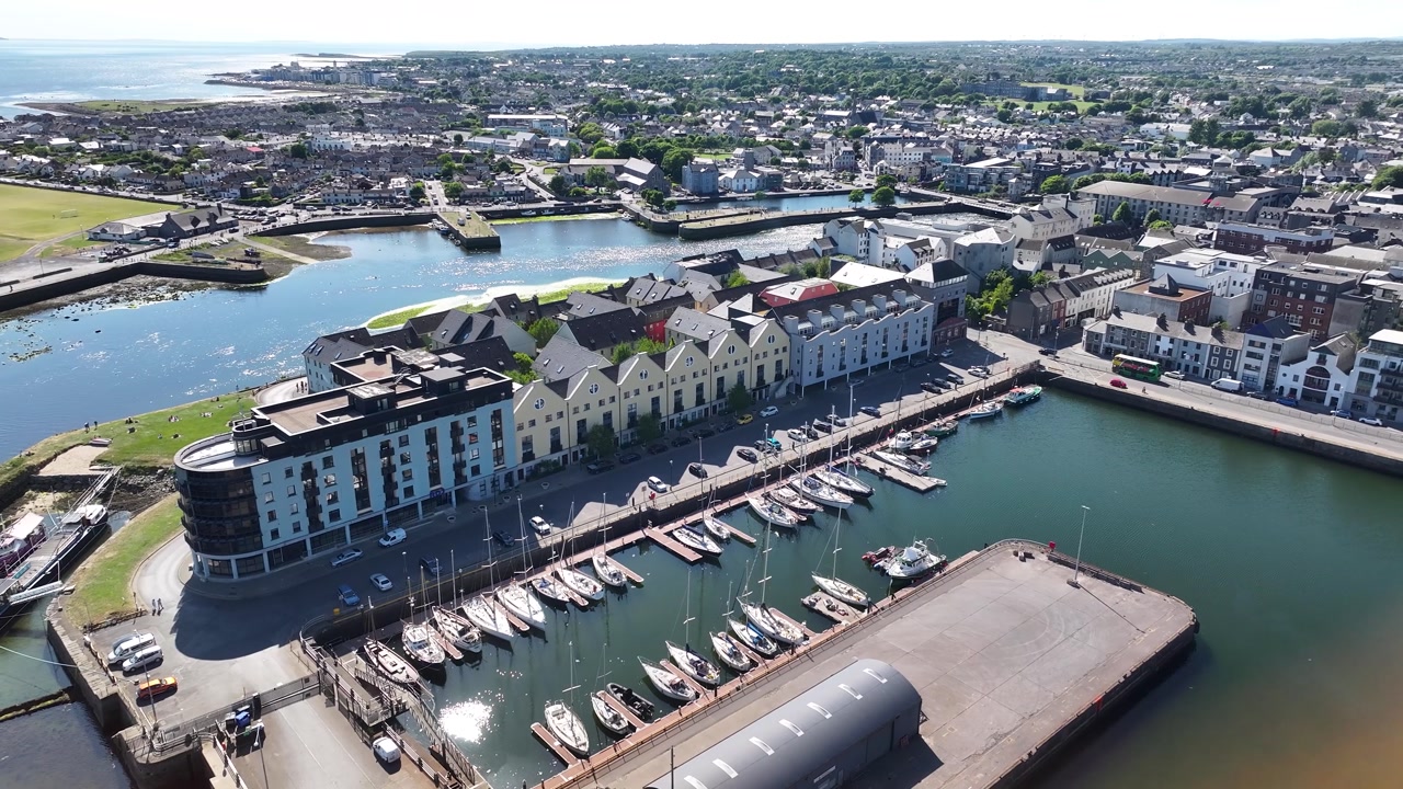 Small marina and quay with boats, seaside of Galway city, urban cityscape. Aerial drone