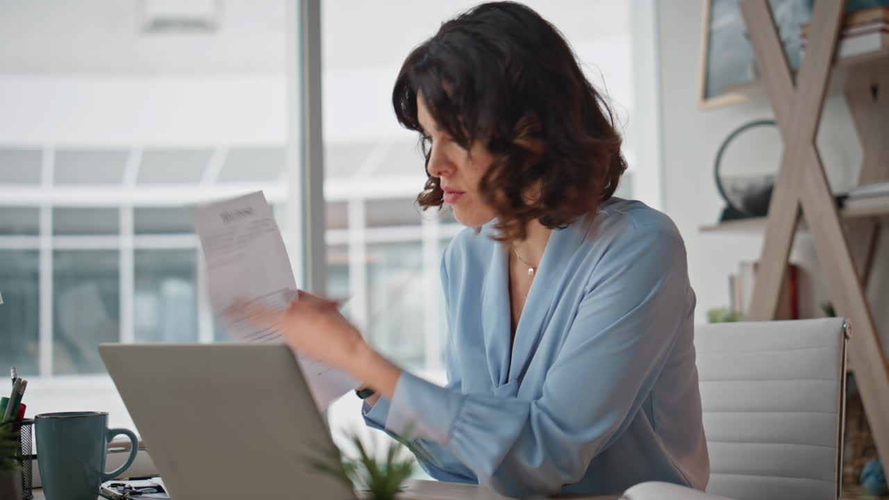 Businesswoman conducting video meeting by laptop at workplace office closeup