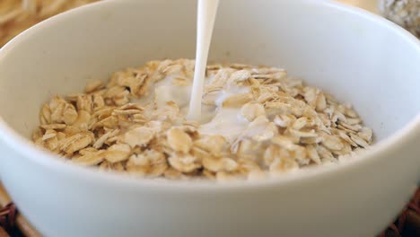 vertiendo leche sobre la harina de avena