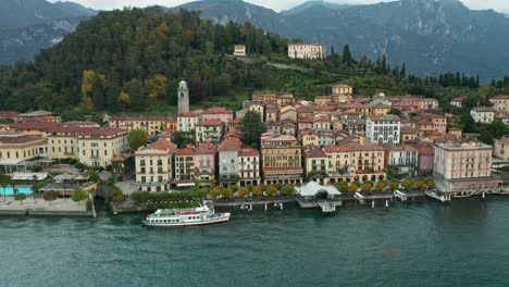 aerial: ferry waits for passengers to board in town of bellagio near lake como