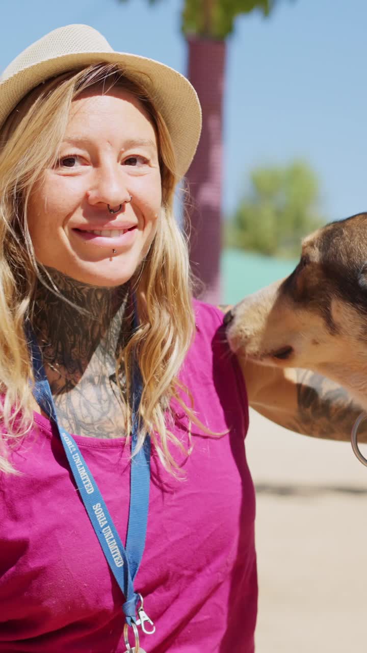 Happy Woman Interacting with Dogs Outdoors on a Sunny Day