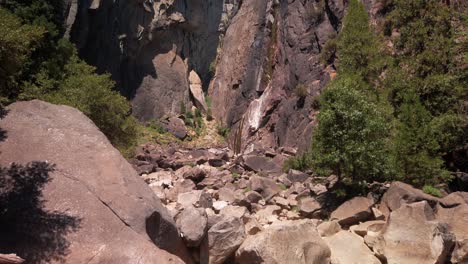 tilting up shot of dried up lower yosemite falls in the summer