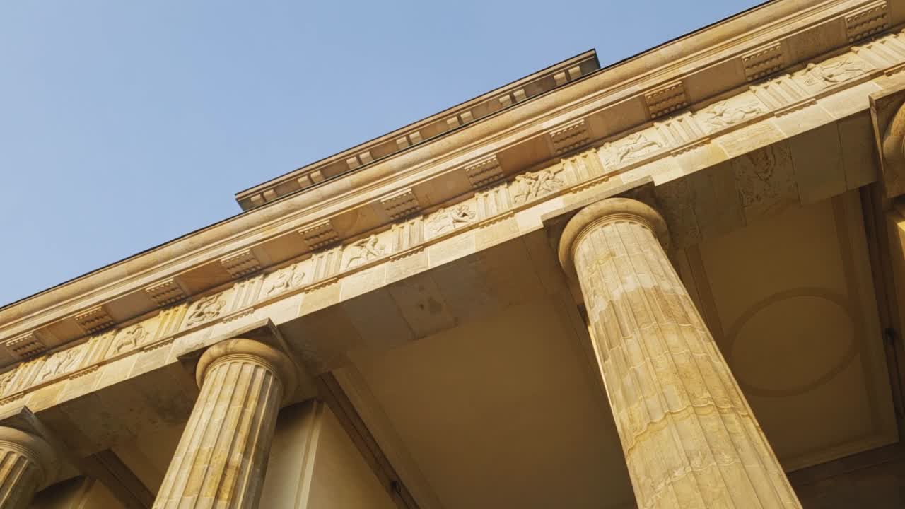 Slow motion entering Brandenburg Gate in Berlin during orange sunset