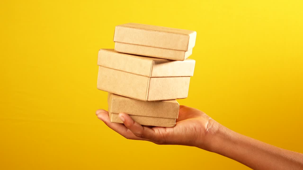 Hand holding stacked gift boxes