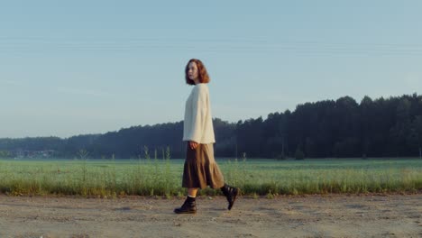 woman walking in a sunrise field