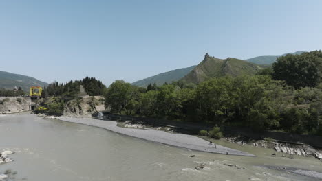 people catching fish at the mtkvari river near the dam in mtskheta-mtianeti, georgia