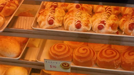 assorted breads and pastries in a bakery display