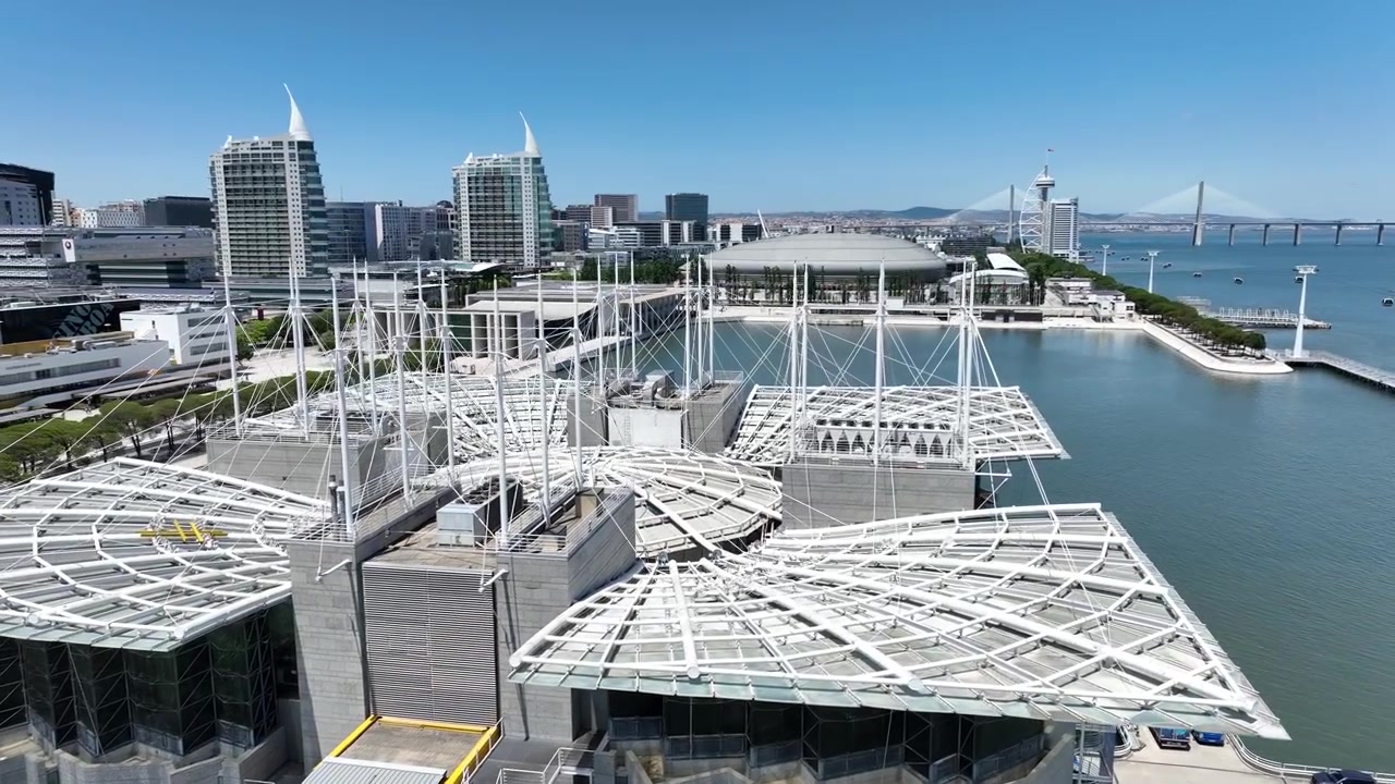 Lisbon Oceanarium In The Parque das Naoces Adjacent To Tagus River On A Sunny Day In Portugal. - aerial
