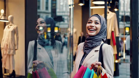 happy woman shopping with colorful bags in front of a storefront