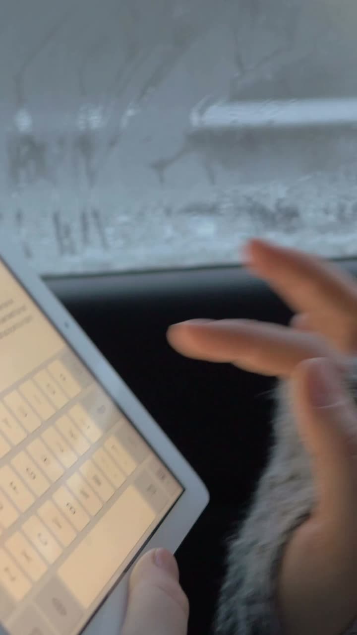 Typing on a tablet in a car during winter