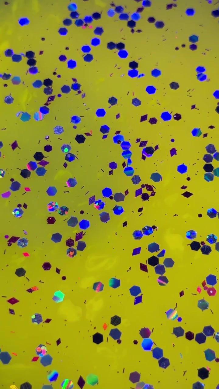 Sfondo giallo con glitter colorati