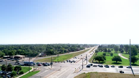 Nondescript-aerial-shot-of-an-urban-intersection-shot-with-tall-horizon-and-sun-bleed