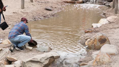 man panning for gold in a stream