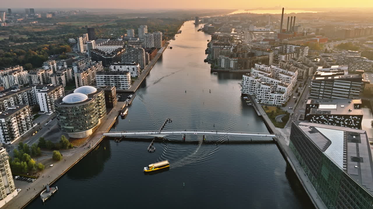 Aerial drone view of the Quay Bridge across the port of Copenhagen, Denmark at sunset