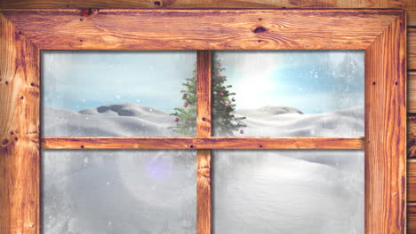 marco de ventana de madera contra la nieve que cae sobre el árbol de navidad en el paisaje de invierno