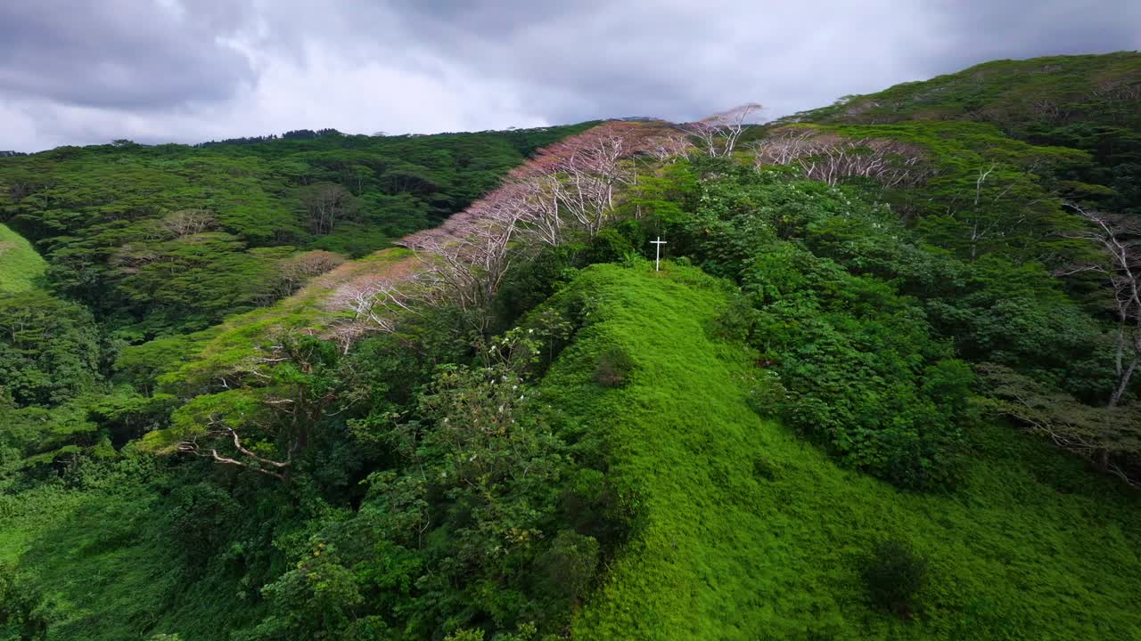 Aerial View of a Cross on a Hilltop in a Lush Tropical Forest